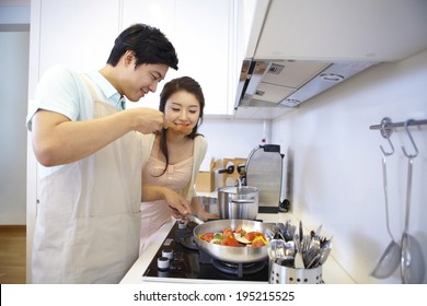 The Image Of A Happy Asian Family Cooking