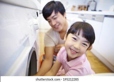 The Image Of A Happy Asian Family Doing Laundry