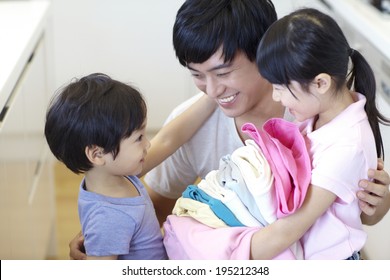 The Image Of A Happy Asian Family Doing Laundry