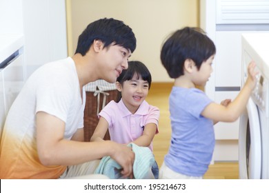 The Image Of A Happy Asian Family Doing Laundry