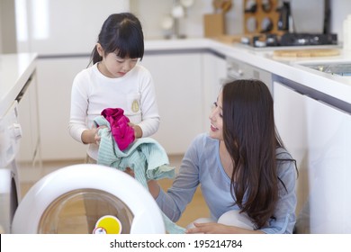 The Image Of A Happy Asian Family Doing Laundry