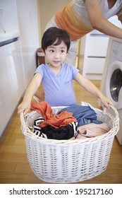 The Image Of A Happy Asian Family Doing Laundry