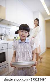 The Image Of A Happy Asian Family In Kitchen