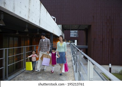 The Image Of A Happy Asian Family Shopping