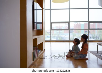 The Image Of A Happy Asian Kids Playing Video Games