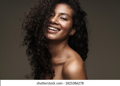 Image of a happy cheery beautiful young african woman with healthy skin isolated over grey wall background - Shutterstock ID 1825386278