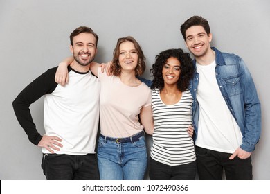 Image Of Happy Group Of Friends Standing Isolated Over Grey Wall Background Looking Camera.