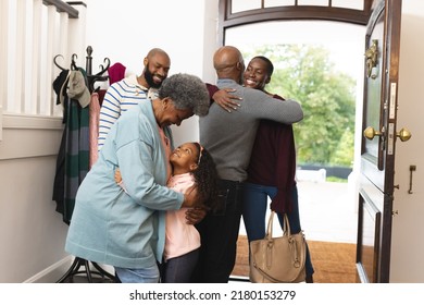 Image of happy multi generation african american family entering house and welcoming each other. Extended family, spending quality time together concept.