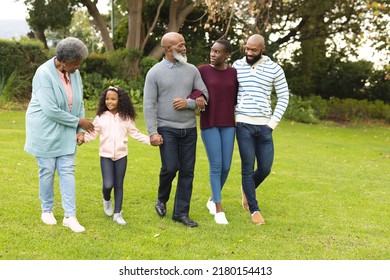 Image Of Happy Multi Generation African American Family Walking Together Outdoors. Extended Family, Spending Quality Time Together Concept.