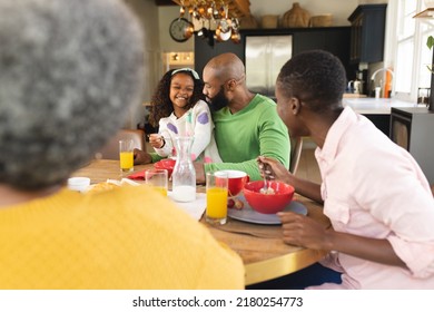 Image of happy multi generation african american family eating breakfast. Family and spending quality time together concept. - Powered by Shutterstock