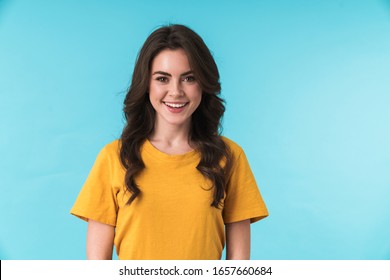 Image Of A Happy Positive Young Pretty Woman Posing Isolated Over Blue Wall Background.