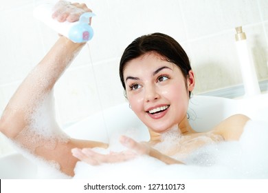 Image Of Happy Woman Going To Wash Herself With Shower Gel In Bath