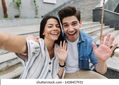 Image Of Happy Young Amazing Loving Couple Business People Colleagues Outdoors Outside Take A Selfie By Camera Waving.