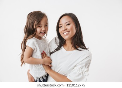 Image of happy young asian woman mother with her little girl child daughter isolated over white wall background. - Shutterstock ID 1110112775