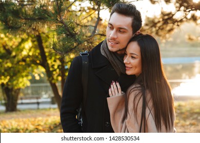 Image of a happy young beautiful loving couple posing walking hugging outdoors in park nature. - Shutterstock ID 1428530534