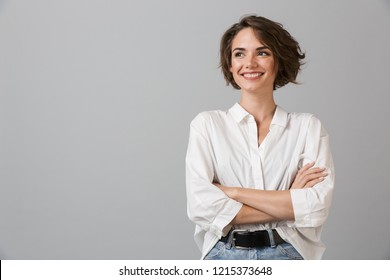 Image of happy young business woman posing isolated over grey wall background. - Powered by Shutterstock