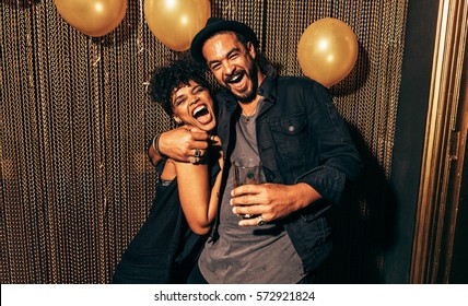 Image of happy young couple having fun at disco. Young man and woman enjoying a party. - Powered by Shutterstock