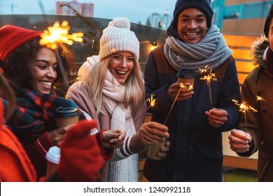 Image of a happy young friends talking with each other drinking coffee outdoors winter concept. స్టాక్ ఫోటో