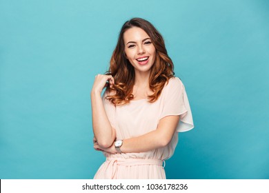 Image Of Happy Young Lady Standing Isolated Over Blue Background. Looking Camera.