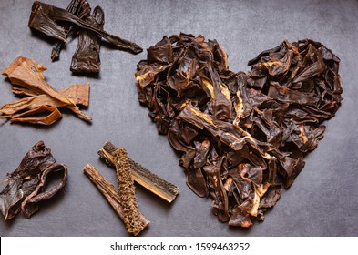 The image of the Heart is laid out from treats for dogs. Natural dried treats for dogs on a dark background. Treats for motivation at dog shows and training. Pet care. Pet supplies. Selective focus.  - Shutterstock ID 1599463252