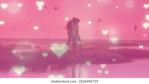 Image of hearts over biracial couple at beach. Holidays, free time and love concept digitally generated image. - Powered by Shutterstock