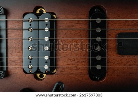 Image of high-quality electric guitar showcasing detailed craftsmanship, glossy pickguard, multiple controls, active pickups, well-maintained frets, and a suggestion of collectors item or profession