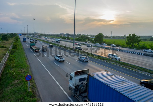 Image of a highway with busy traffic in the
evening in Thailand.