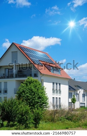 An image of a home with solar energy green plants and sunny blue sky