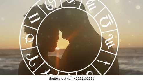 Image of horoscope over happy biracial couple embracing at beach. Lifestyle, nature, horoscope and symbols concept digitally generated image. - Powered by Shutterstock