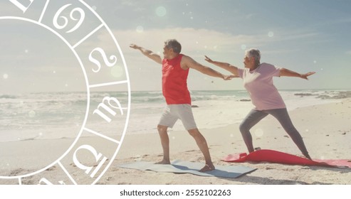 Image of horoscope over happy senior biracial couple practicing yoga at beach. Lifestyle, nature, horoscope and symbols concept digitally generated image. - Powered by Shutterstock