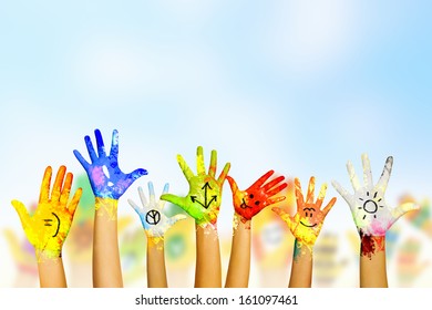 Image of human hands in colorful paint with smiles - Shutterstock ID 161097461