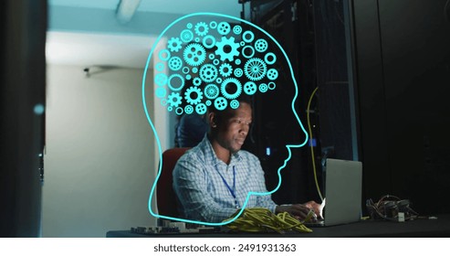 Image of human head ai data processing over african american man using laptop. Global artificial intelligence, data processing, computing and digital interface concept digitally generated image.