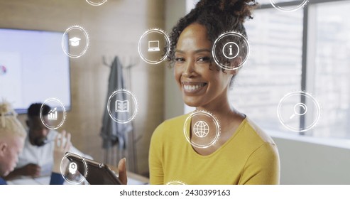 Image of icons and data processing over biracial businesswoman in office. Global business, finances, computing and data processing concept digitally generated image.