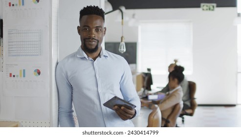 Image of icons and data processing over african american businessman in office. Global business, finances, computing and data processing concept digitally generated image. - Powered by Shutterstock