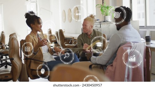 Image of icons and data processing over diverse business people in office. Global business, finances, computing and data processing concept digitally generated image.