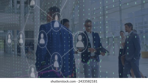Image of icons and data processing over diverse business people working in office. Global digital interface, cloud computing and data processing concept digitally generated image.