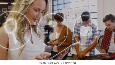 Image of icons and data processing over diverse business people in office. Global business, finances, computing and data processing concept digitally generated image.