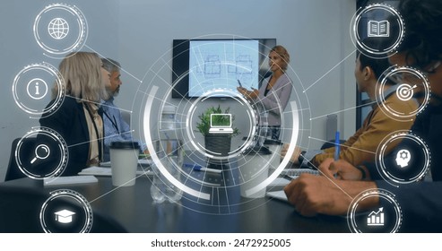 Image of icons and data processing over diverse business people in office. Global business, finances, computing and data processing concept digitally generated image.