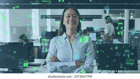 Image of icons and data processing over asian businesswoman in office. Global business, finances, computing and data processing concept digitally generated image.