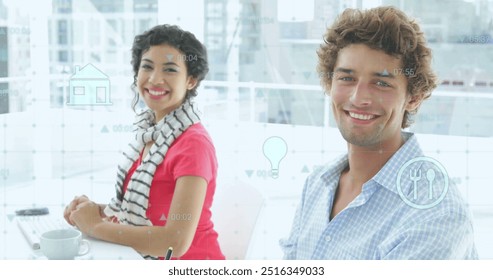 Image of icons and data processing over caucasian male and female colleague at casual office. Network, data, digital interface, teamwork, business and communication, digitally generated image.