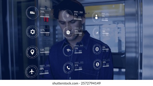 Image of icons and data processing over caucasian man working in warehouse. Global shipping, finance, business, connections, computing and data processing concept digitally generated image.