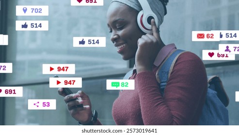 Image of icons and data processing over african american woman using smartphone. Global social media, connections, computing and data processing concept digitally generated image.