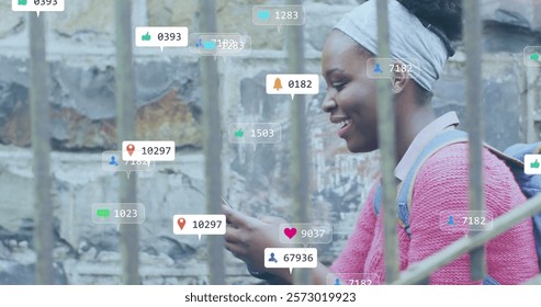 Image of icons and data processing over african american woman using smartphone. Global social media, connections, computing and data processing concept digitally generated image.
