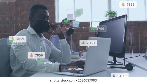 Image of icons and numbers over african american man in face mask using smartphone. Global social media, business, cloud computing and data processing concept digitally generated image. - Powered by Shutterstock - Get 15% off with code: PIKWIZARD15