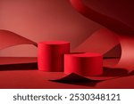 The image is ideal for presenting products, featuring two red cylindrical podiums on a red background, curled and arched over by a large piece of red paper curled and arched over them.