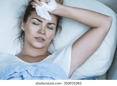 Image Of Ill Woman With Headache Resting In Bed