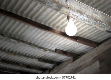 An Image Of An Incandescent Light Bulb In A Rural Hut, Rural Electrification.