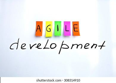 Image inscriptions of agile development. Agile methodology writing colors stickers isolated on white background of white board.