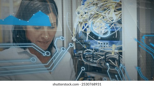 Image of interface with data processing over biracial female engineer working at server room. Computer interface and business data storage technology concept