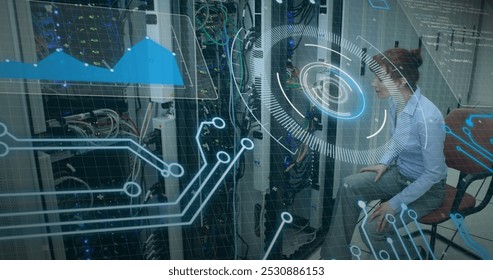 Image of interface with data processing over caucasian female engineer working at server room. Computer interface and business data storage technology concept